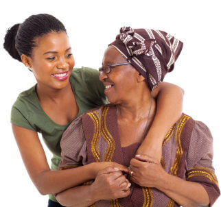 senior woman and caregiver smiling at each other